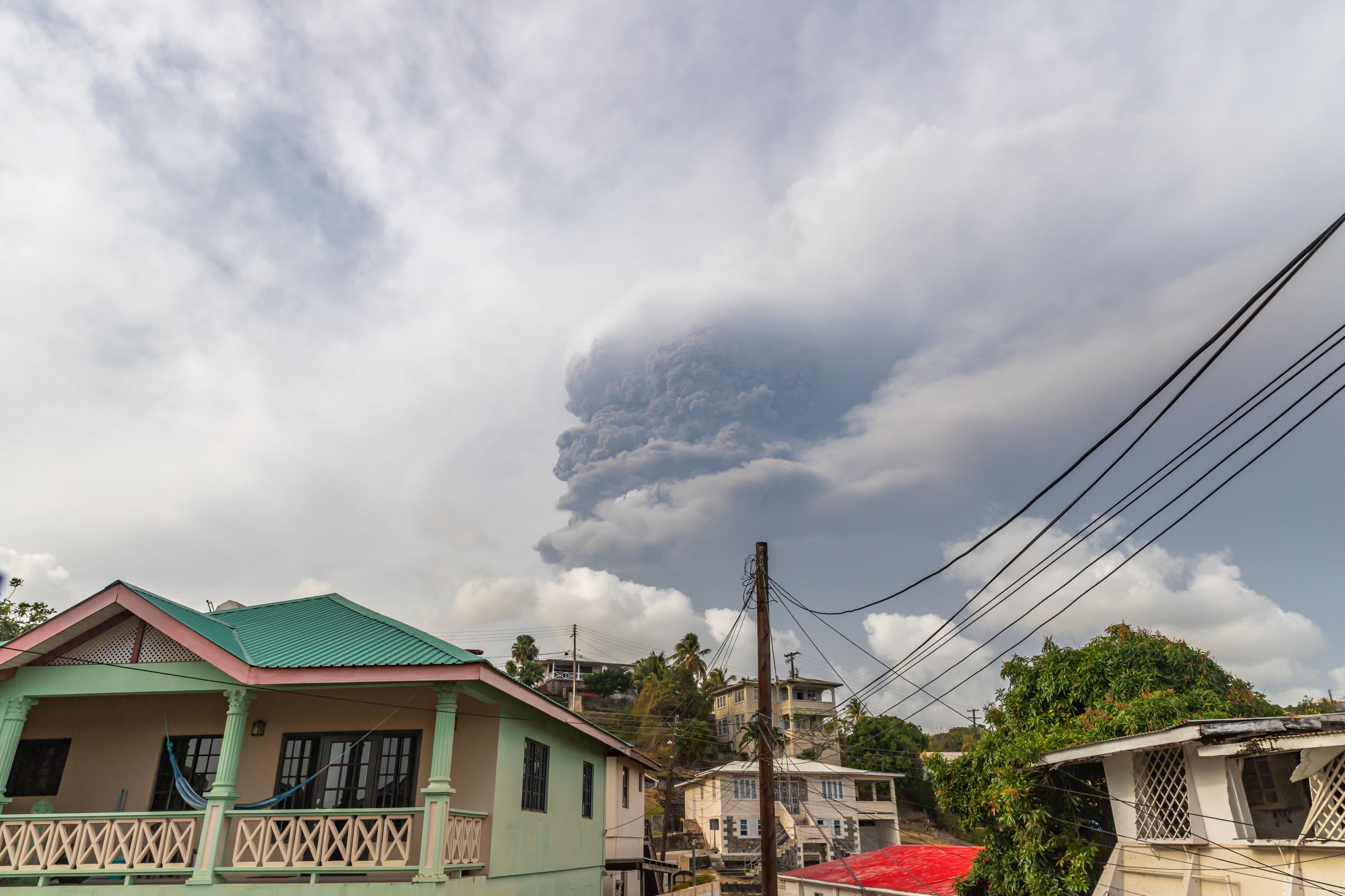 clouds of ash rise above homes in St. Vincent after volcano eruption