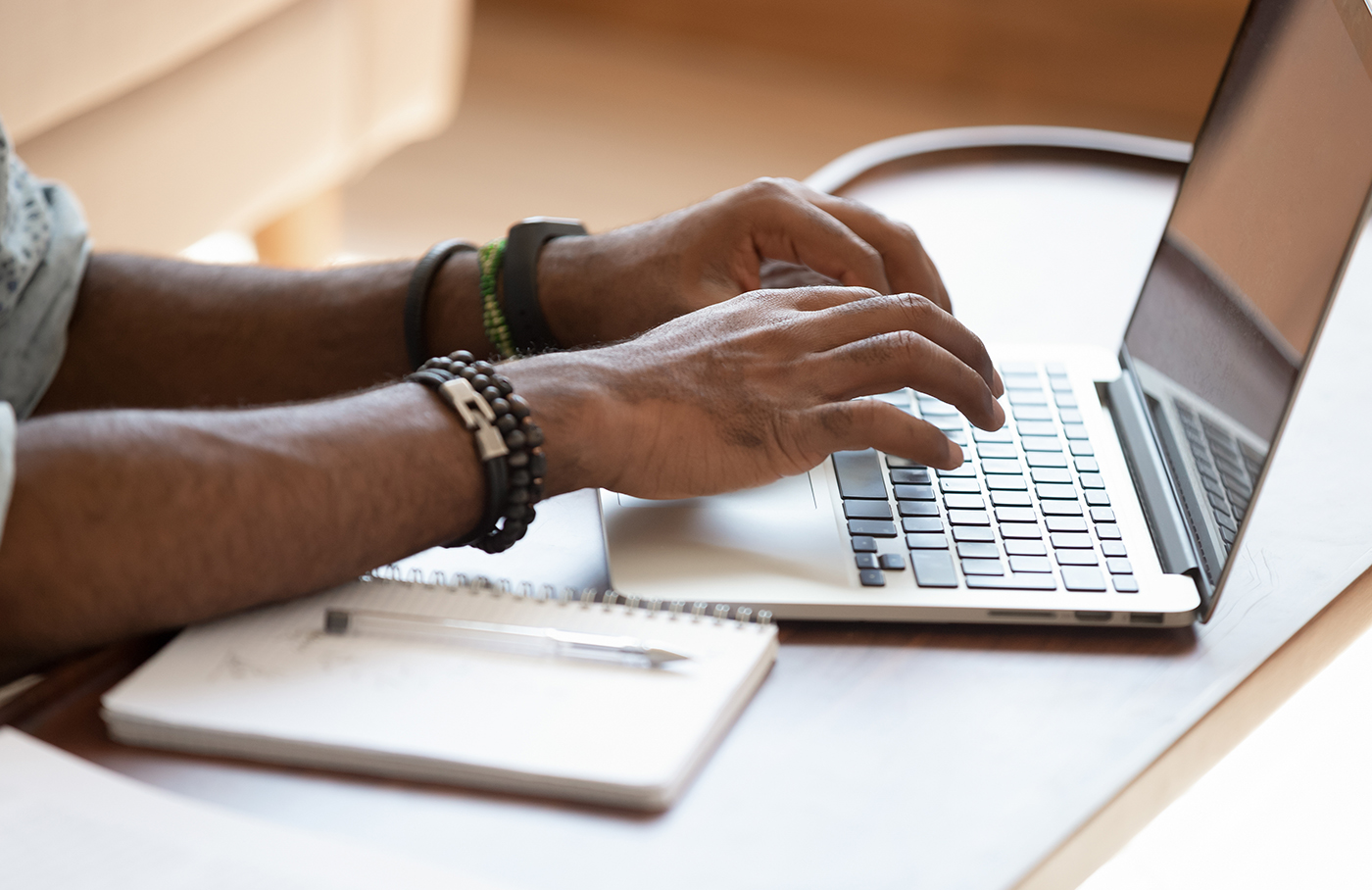 hands typing on computer