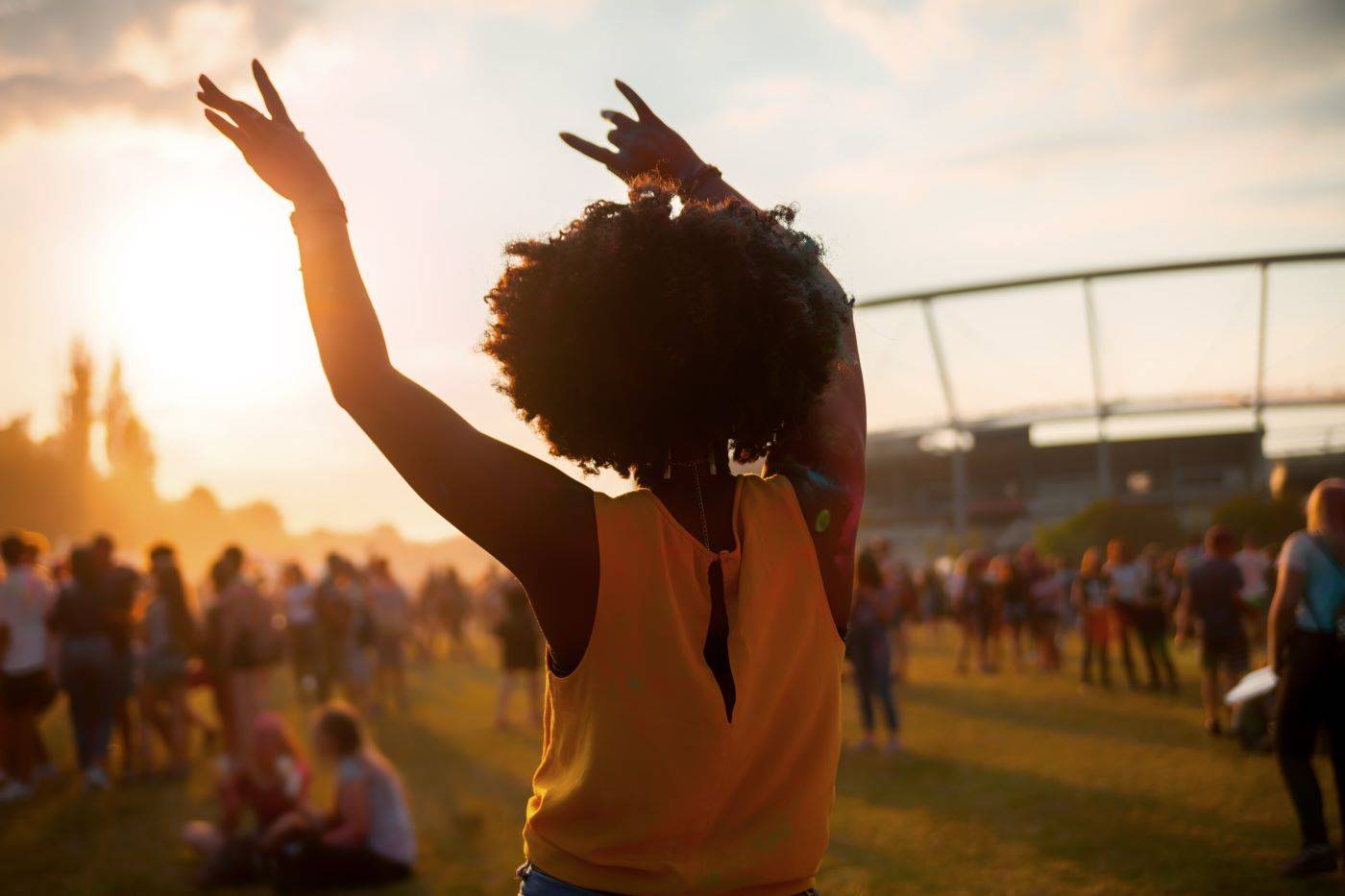 Lady waving hands in air at music festival