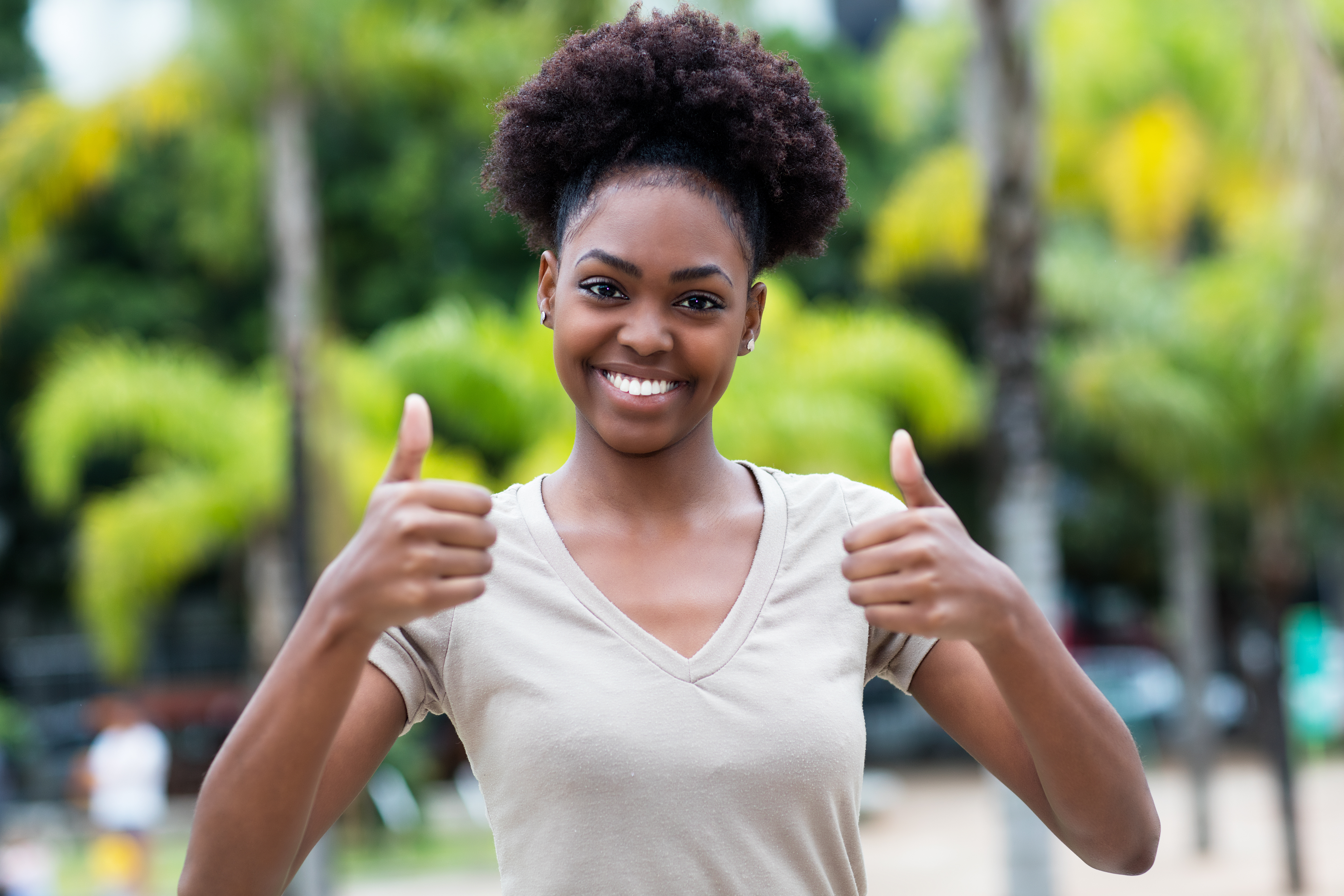 Woman with both thumbs up