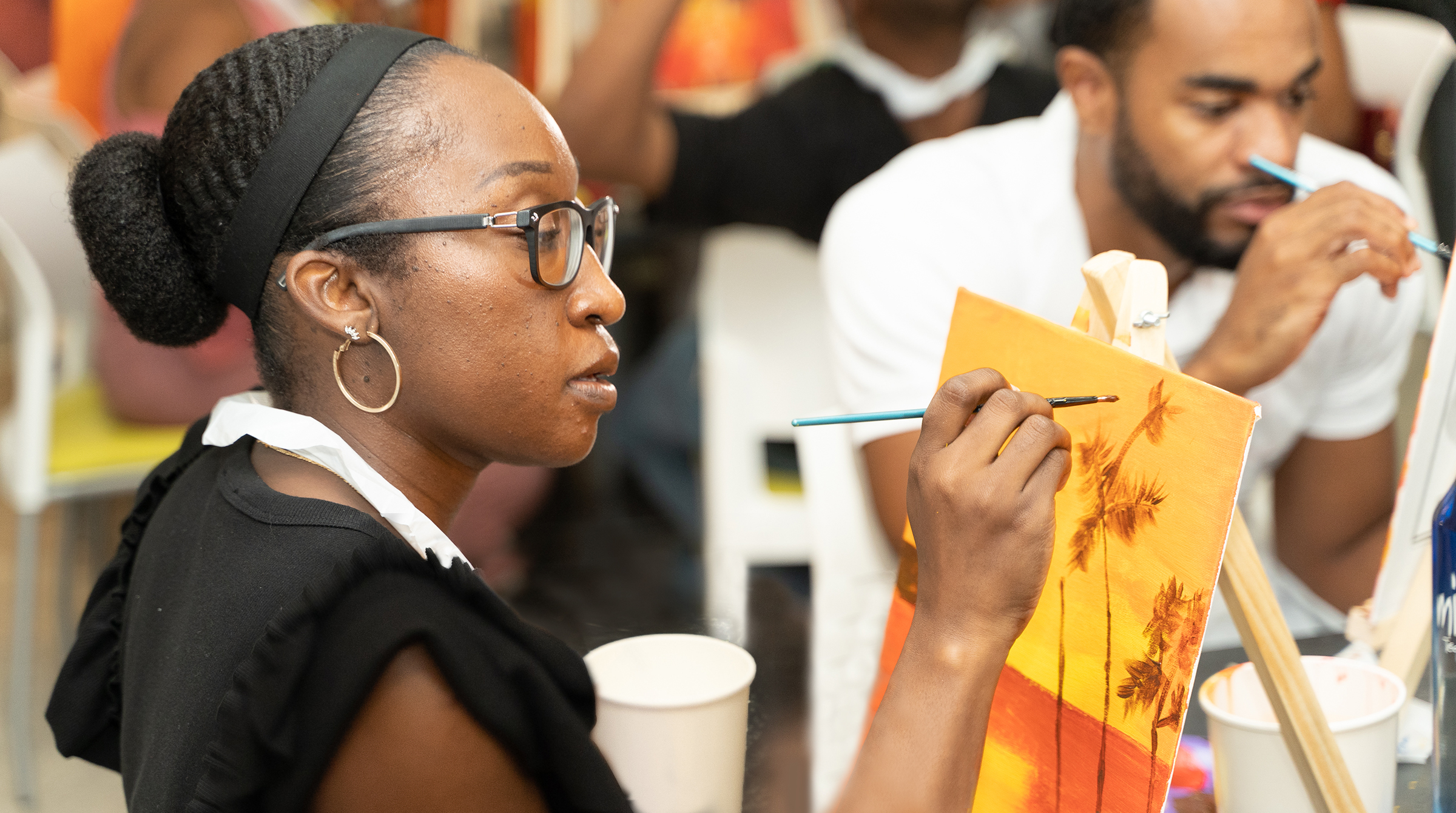 female staff member focused as she paints