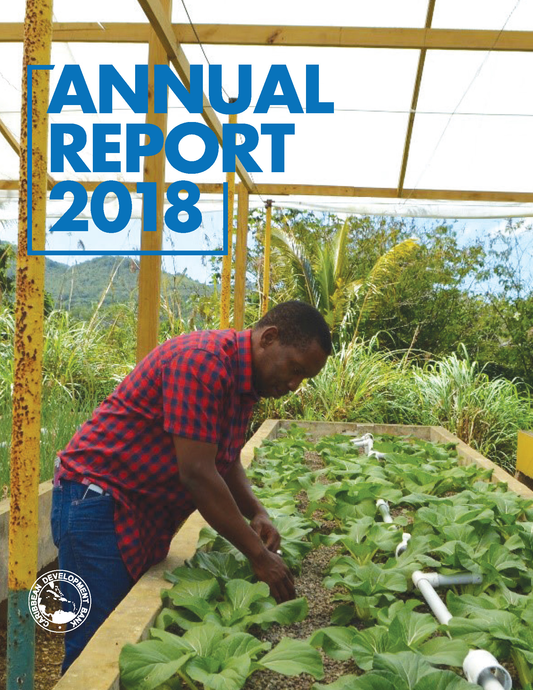 man in red checked shirt tending to plants grown at an aquponics agri-business