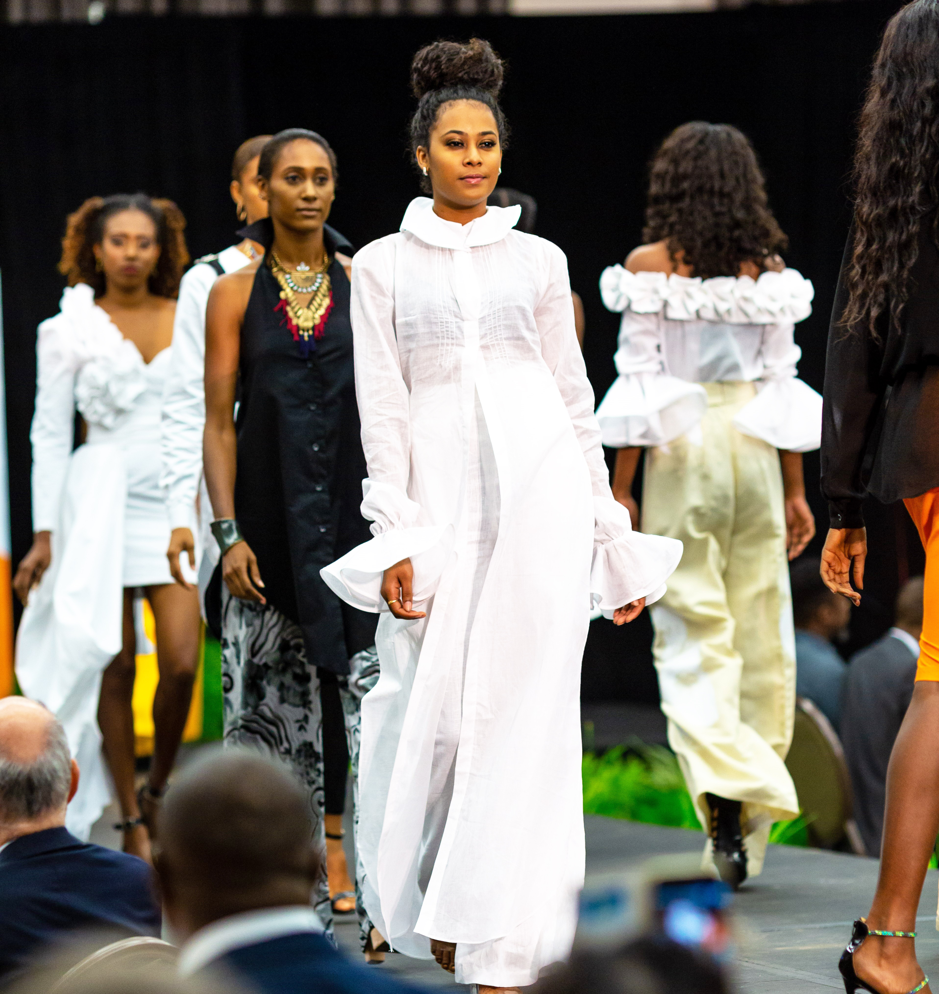 Models in linen clothing on a catwalk.