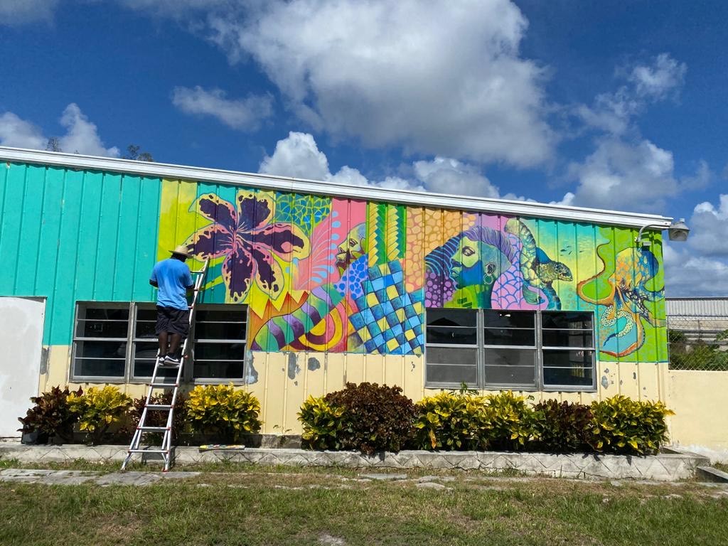 Artist paining a mural