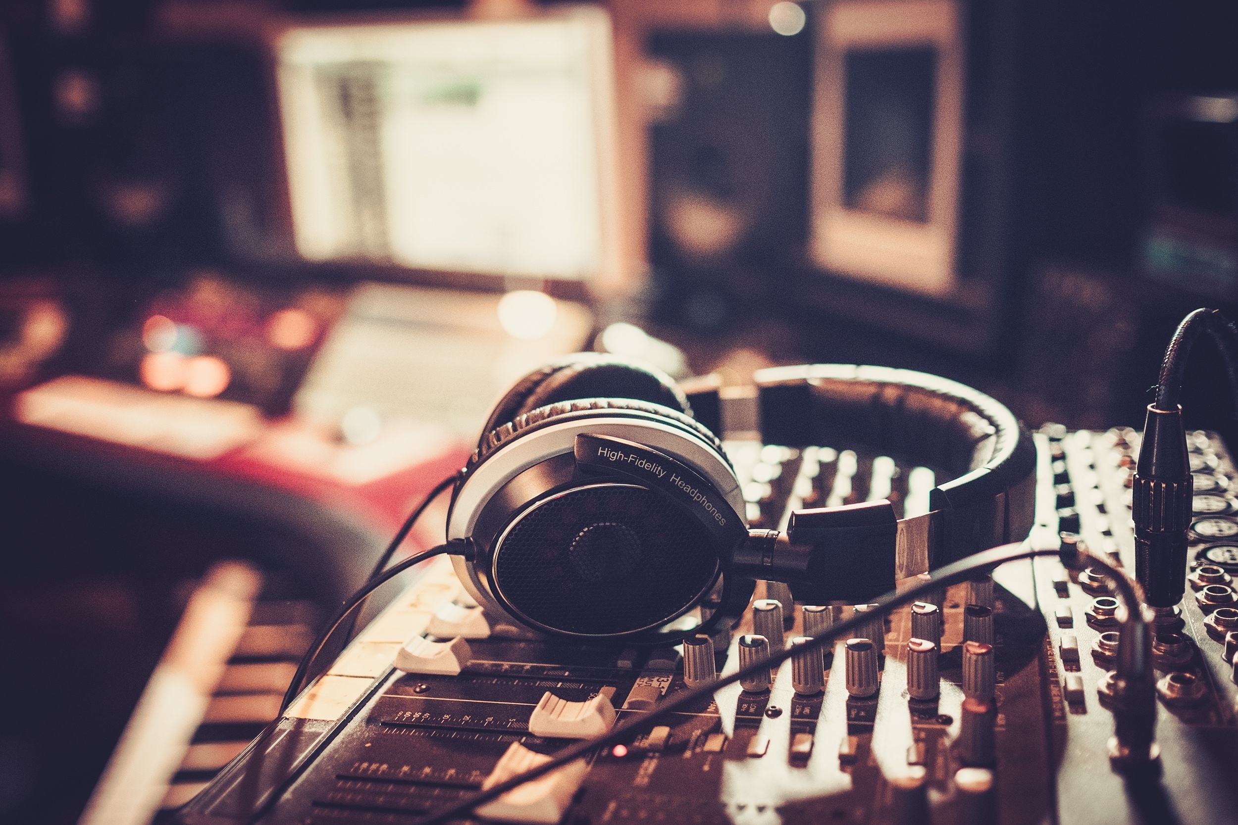 headphones in music studio with computer in background