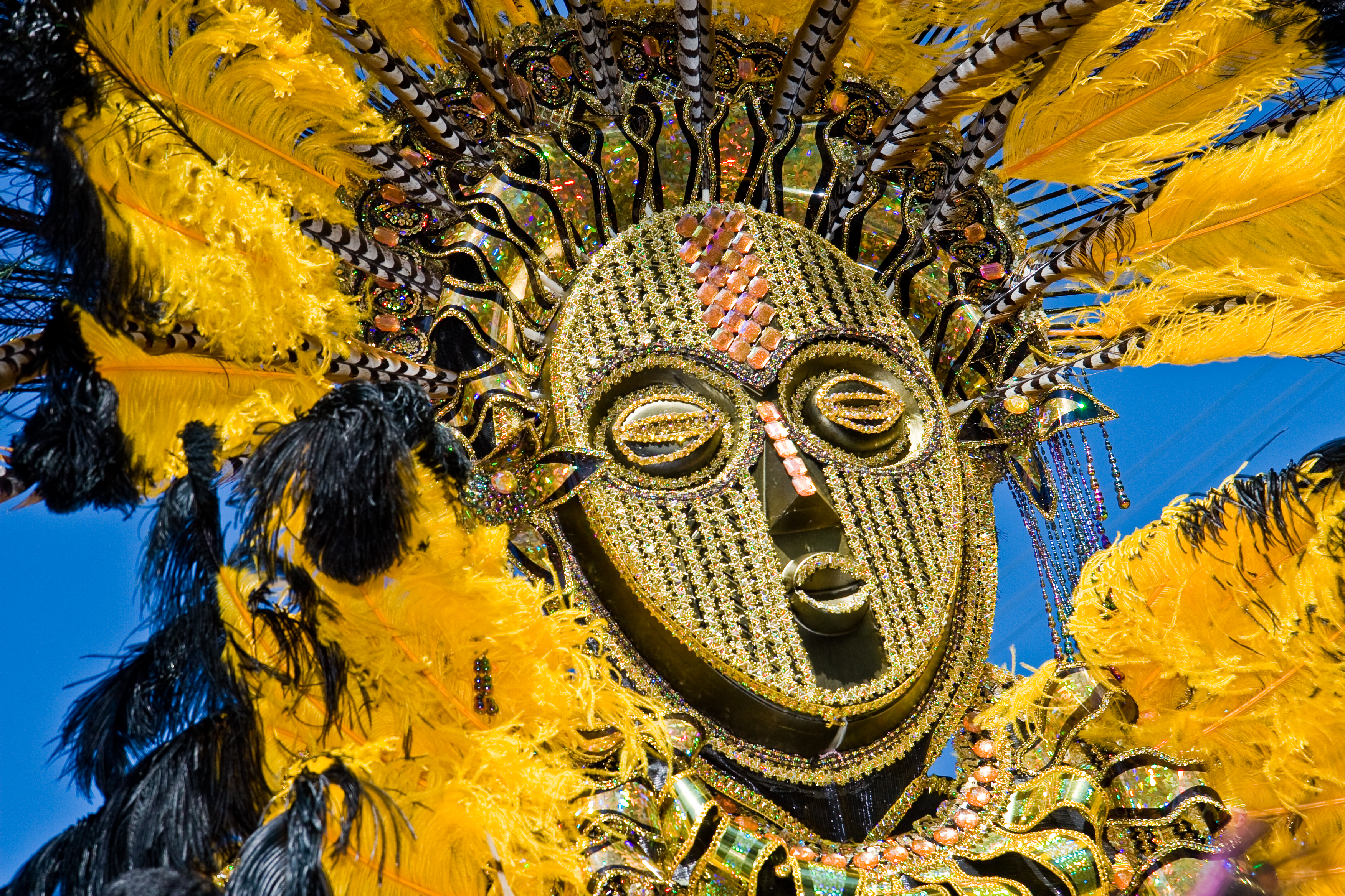 gold and yellow carnival costume against blue sky