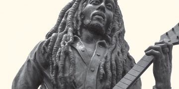 Beige cover with black and white photo of statue of Bob Marley