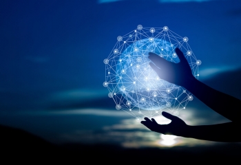 hands holding a digital rendering of the globe