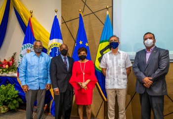 group photo of five persons, including one female int he middle