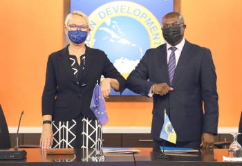 EU Ambassador Malgorzata Wasilewska and CDB Vice-President Isaac Solomon bump elbows