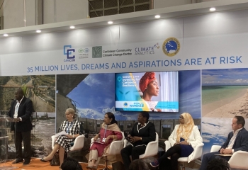 Row of speakers seated in CARICOM pavilion at COP 27