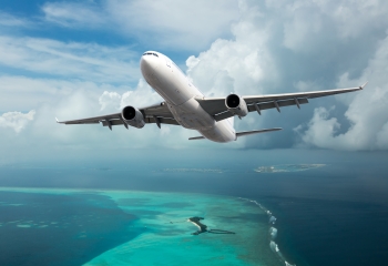 plane flying over Caribbean sea