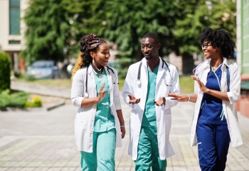 Health care workers walking and talking outside