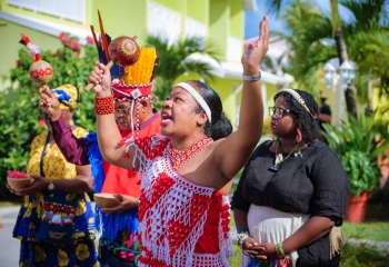 Anushka Christiaan, Amerindian Village Representative, Suriname, worshipping during a smoke ceremony 