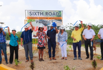 group photo of stakeholders standing on upgraded coastal highway