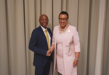 image of male and female executives shaking hands