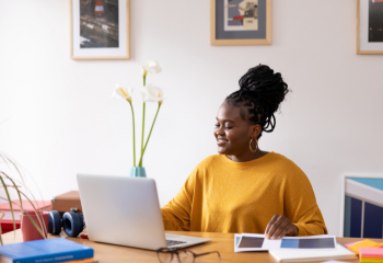 Black woman in her 20s working from her modern home office