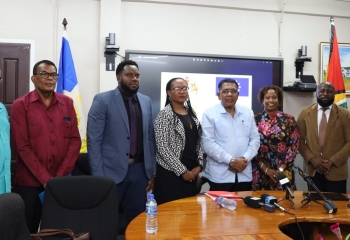 Cross section of CDB and Government of Guyana Representatives standing at project launch event 