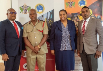 Elbert Ellis Saint Lucia's Chief Fire Officer and two other Government officials standing 