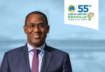 The image features Dr. Nigel Clarke, Deputy Managing Director of the International Monetary Fund, wearing a dark suit, light blue shirt, and patterned tie. He is smiling and positioned in front of a blurred background with subtle blue tones. The logo for the 55th Annual Meeting of the Caribbean Development Bank (CDB), scheduled for June 9-12, 2025, in Brasília, Brazil, is prominently displayed in the top right corner.