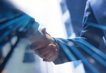 Businessmen making handshake with partner