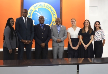seven persons standing in a row in business attire 