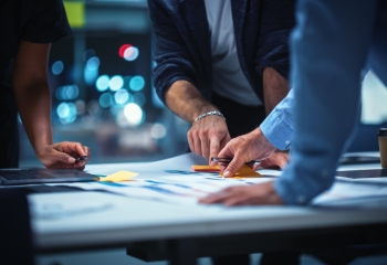 Hands of a Diverse Team of Top Managers Talking and Brainstorming 