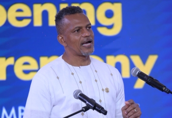 Caribbean Development Bank President Daniel M. Best delivering opening remarks at the 2025 Regional Symposium on Transforming Education, standing at a podium with microphones