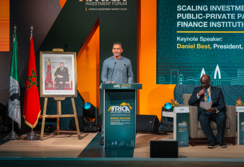 CDB President Daniel Best standing in light grey formal attire at lectern looking straight ahead delivering remarks