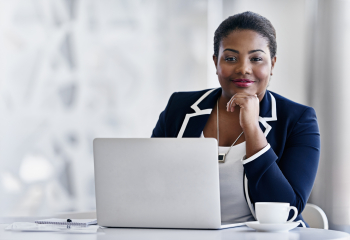 Professional woman seated at a computer