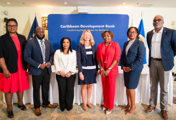 Group of partners from EU, CDB, CARIFORUM and Government of Barbados standing and smiling