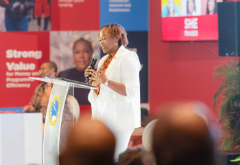 Business woman at podium addressing a crowd