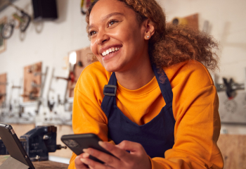 Young woman in workshop smiling