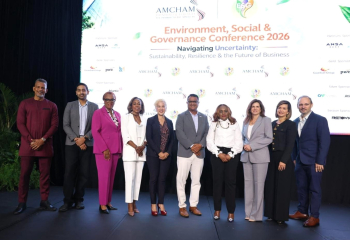 Group photo of conference speakers and key participants standing on stage at the AMCHAM Trinidad and Tobago Environment, Social & Governance Conference 2026
