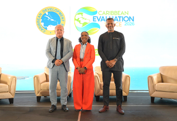 Three keynote speakers on stage at the Caribbean Development Bank's Caribbean Evaluation Space launch