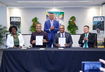 Representatives from the Government of Jamaica, the Caribbean Development Bank, and the Rural Water Supply Limited applaud the new agreement.