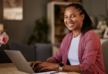Smiling business woman at her home office desk