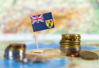 Turks and Caicos flag with coins on map