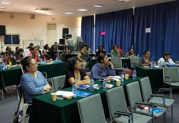 seated audience members paying close attention to presenter during workshop