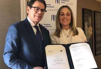 CDB President, Dr. William Warren Smith and EIB Vice-President, Emma Navarro with the signed agreement