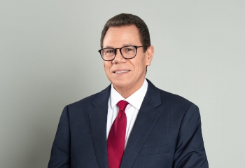 profile photo of Dr. Smith wearing a dark suit with a white shirt and maroon tie