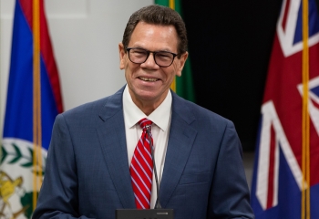 CDB President Dr Wm Warren Smith, wearing a blue suit and a red tie