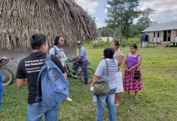 group of persons outside a village in Belize