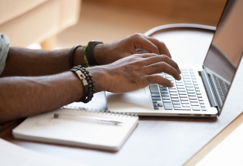 hands typing on computer