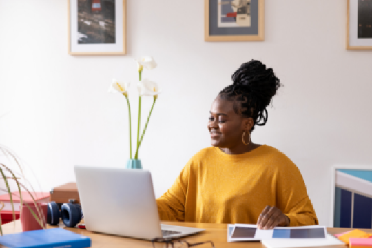 Black woman in her 20s working from her modern home office